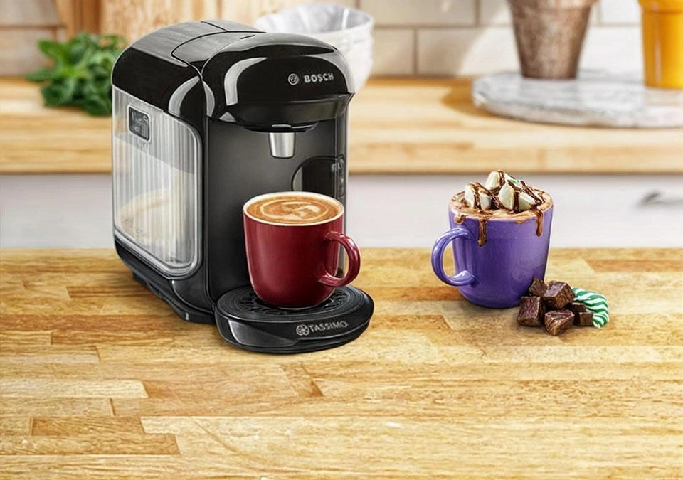 TASSIMO: The coffee machine with two mugs featuring a creamy latte and a chocolate drink topped with marshmallows.