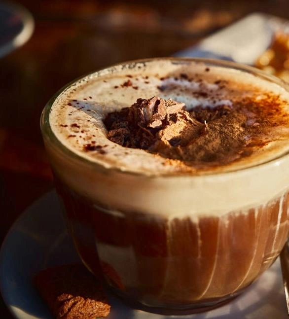 TASSIMO hot chocolate with whipped cream and chocolate shavings.