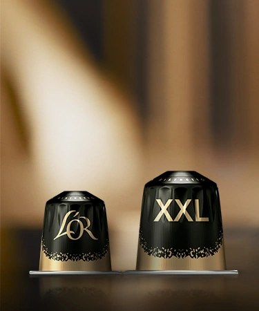 Colorful L'OR Espresso capsules on a shiny black surface, arranged for a striking display.