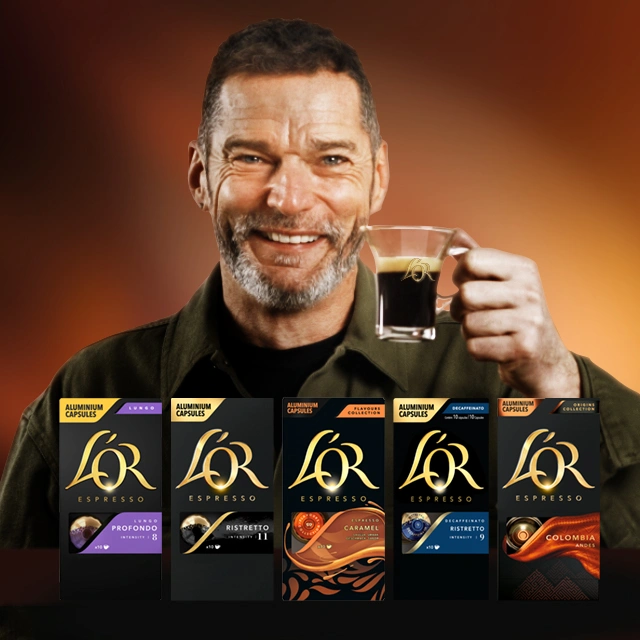 Close-up of Fred Sirieix raising a L'Or espresso cup