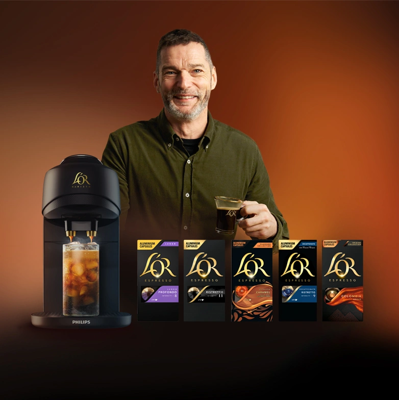 Fred Sirieix enjoying espresso next to L’OR Barista Absolu machine presenting L'Or coffee flavours