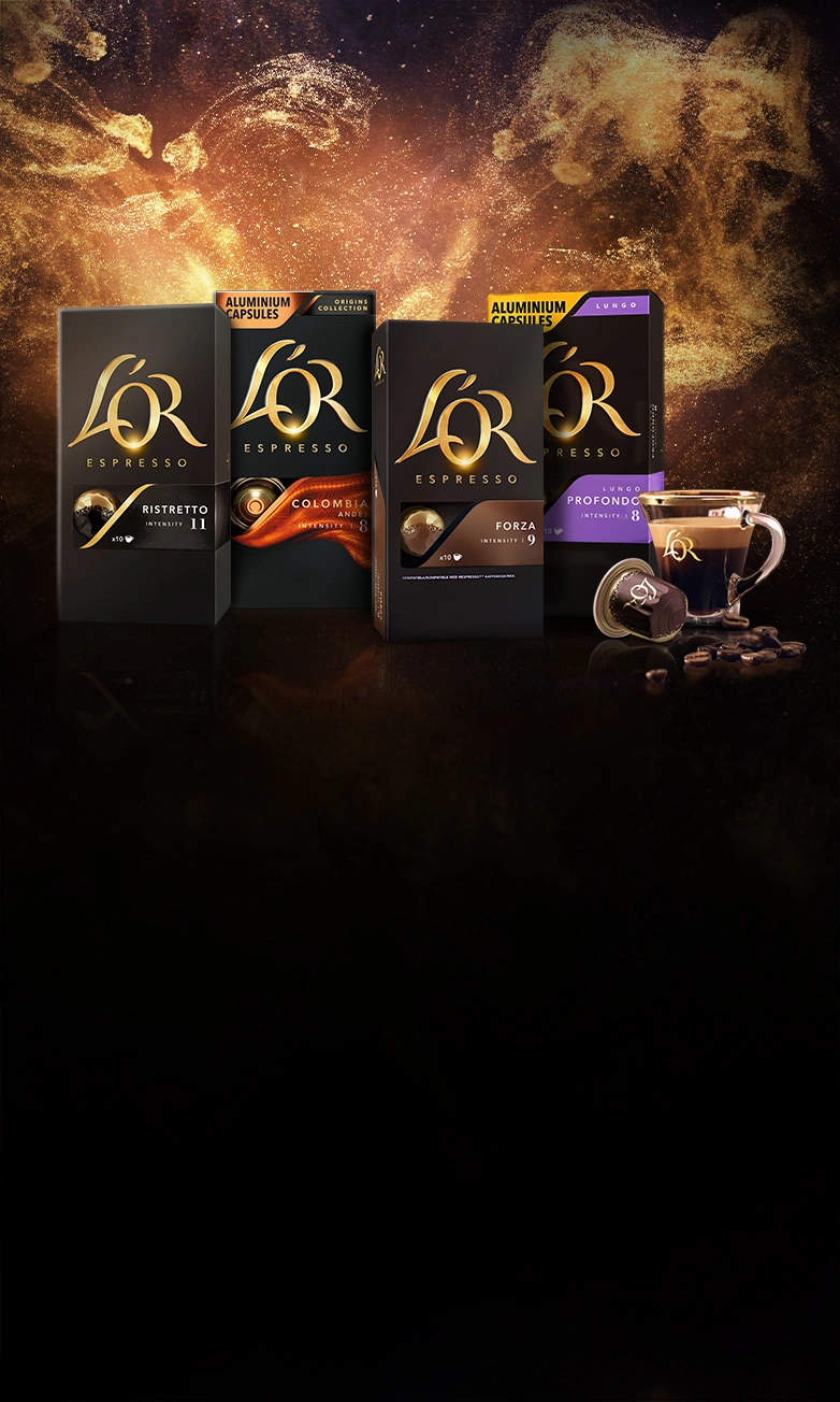 Variety of L'OR Ristretto, Colombia, Forza and Profondo packs. L'OR capsule and and espresso cup. Golden glitter background.