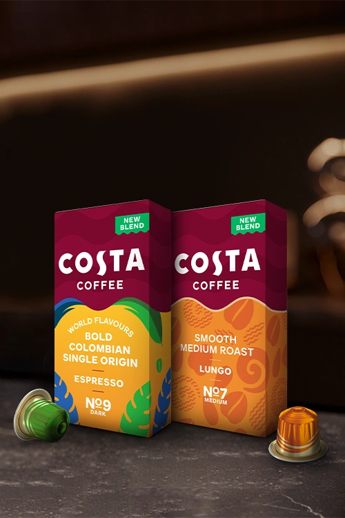 L'OR Costa coffee packs and capsules on a dark counter.