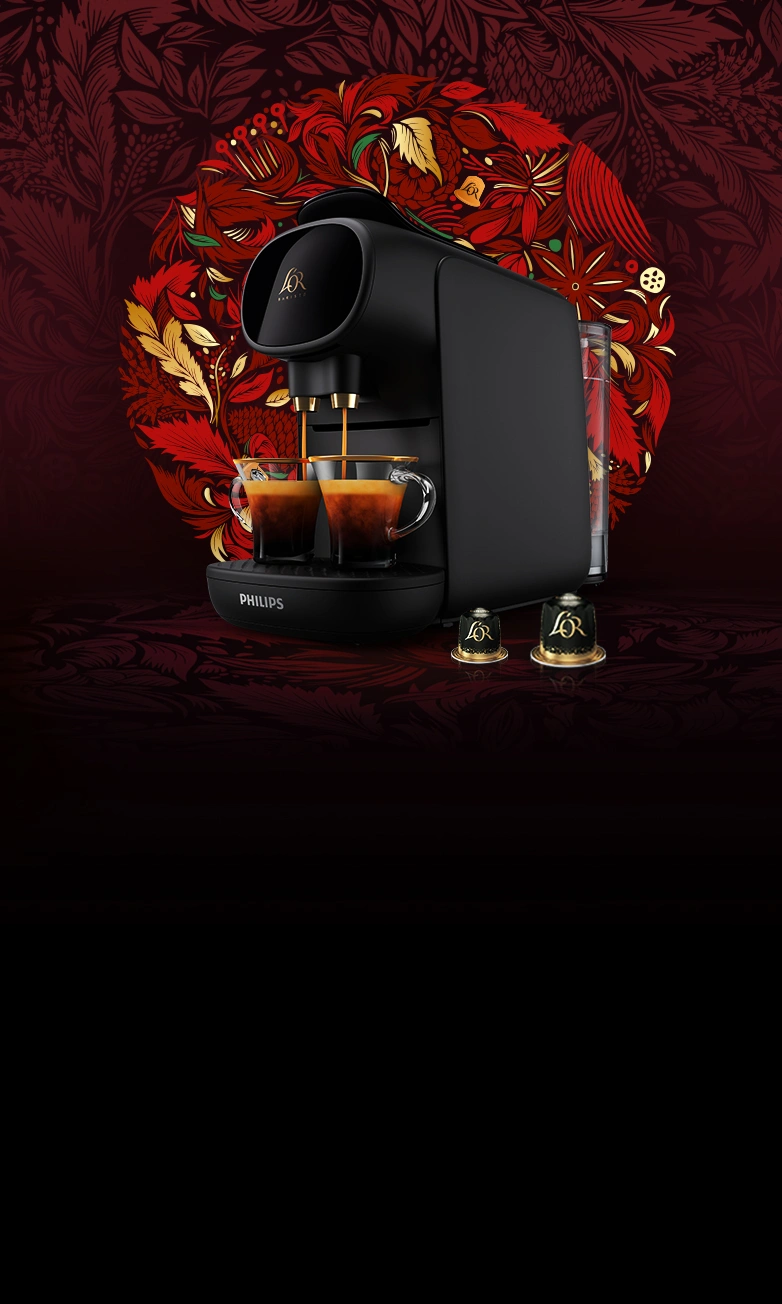 Machine à café noire L’OR Sublime et capsules sur un fond de couronne rouge.