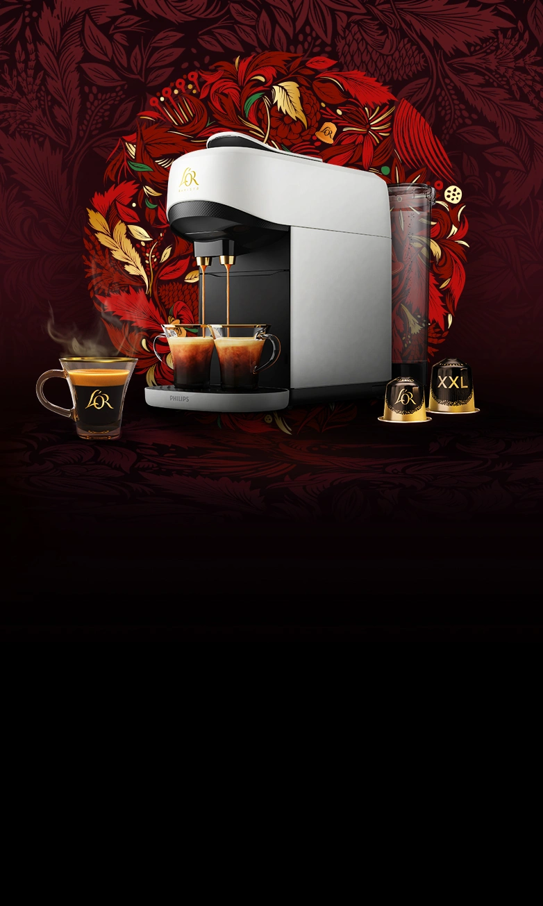 White L'OR Absolu coffee machine with coffee cups and Ristretto normal and XXL capsules on a red wreath background.
