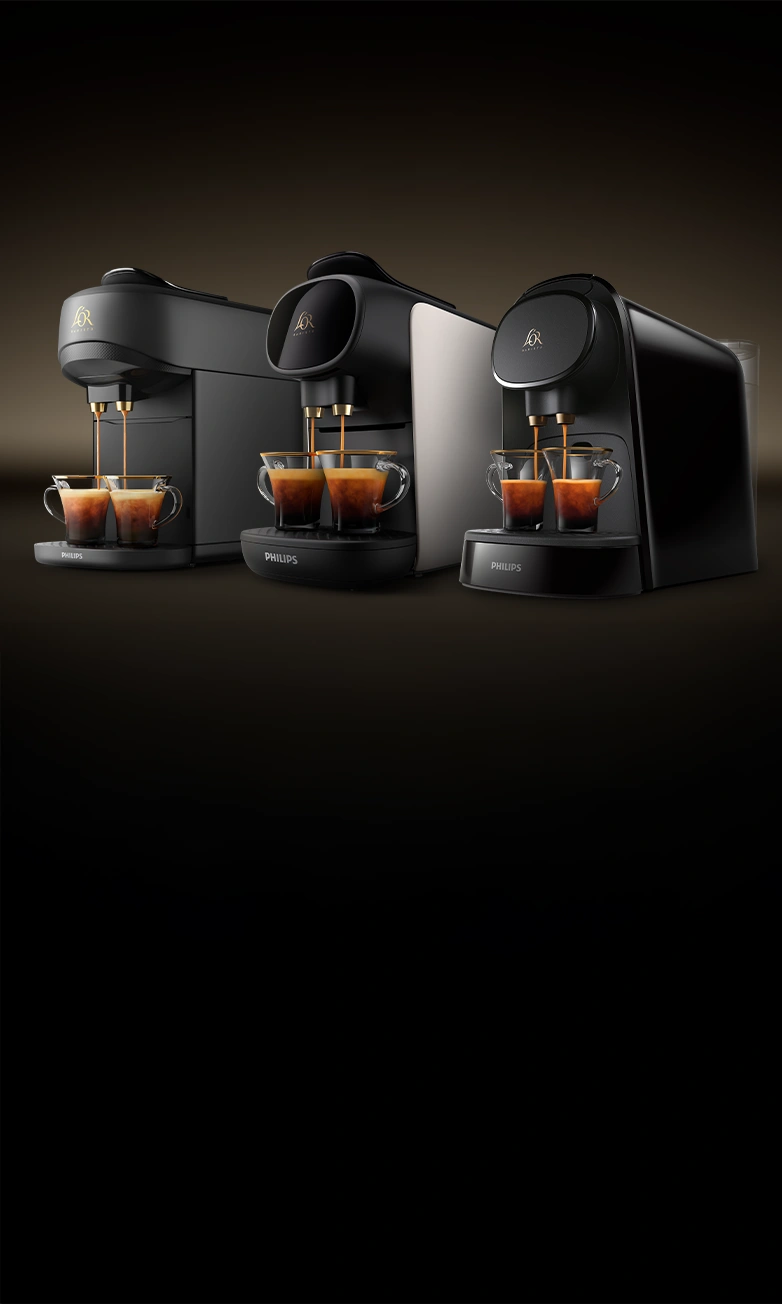 Trio of L’OR BARISTA machines in black and white, each brewing two espressos, placed side-by-side on a dark gradient background.