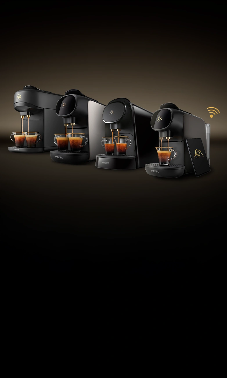 Four L’OR BARISTA coffee machines brewing espressos side by side on a dark gradient background.