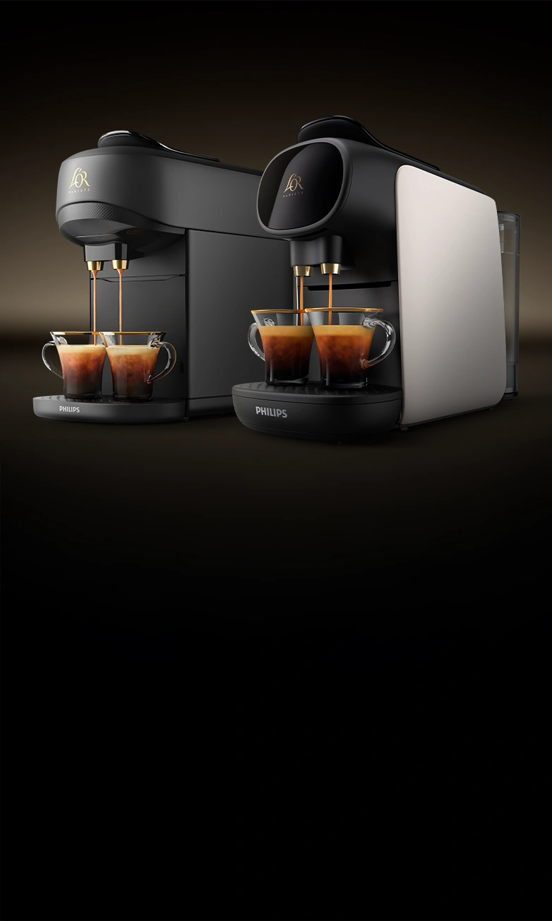 Two L’OR BARISTA coffee machines brewing espressos side by side on a dark gradient background.