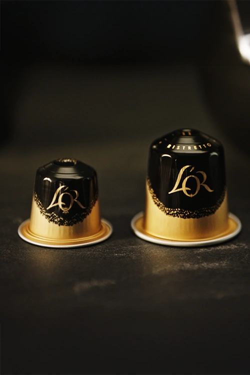 2 L'OR Espresso Coffee capsules next to each other, 1 regular size and 1 XXL size