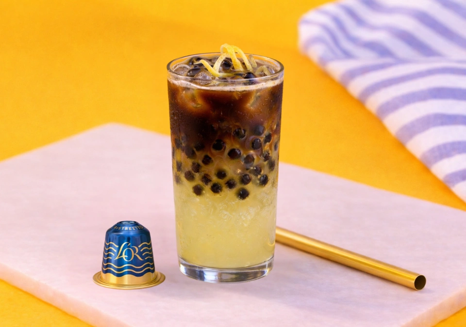 A glass of Capri Citrus Espresso Burst with L'OR Espresso Capsule and Straw