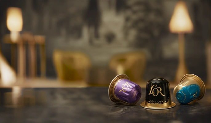 L'OR Espresso Coffee Capsules on a luxurious marble tabletop