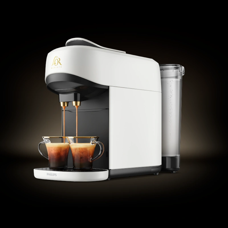 White L’OR Barista machine brewing two espressos, showing the water tank and sleek design.