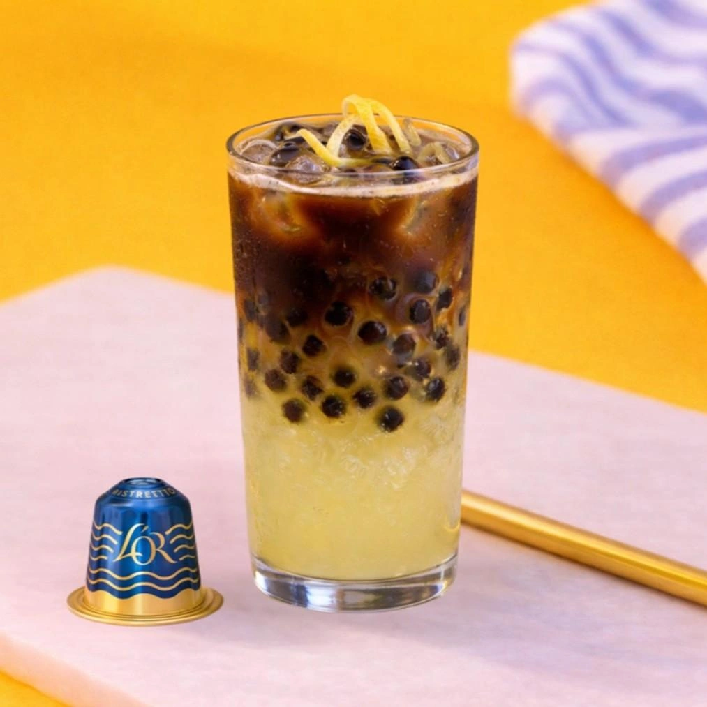 A glass of Citrus Espresso Burst made with L'OR Espresso Capri Dolce Vita and coffee pearls