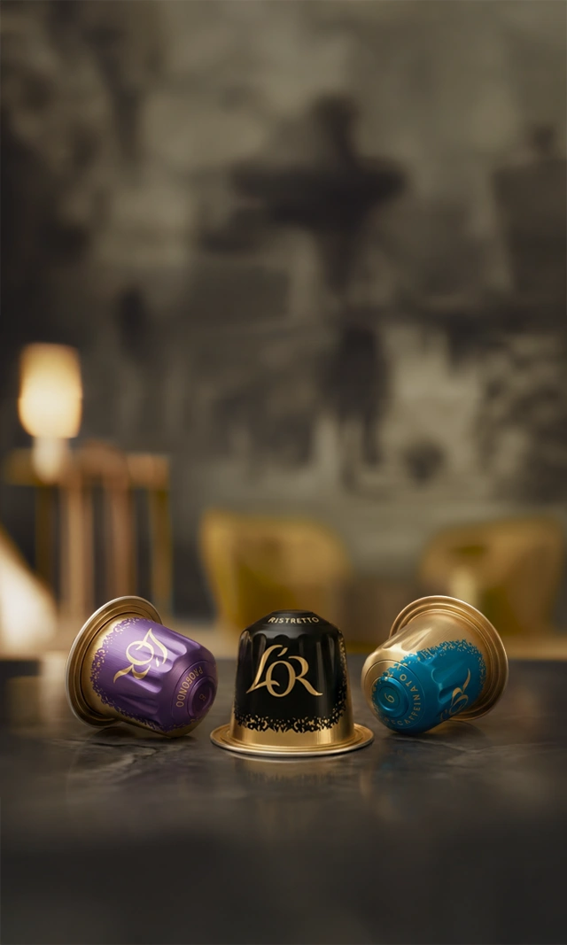 L'OR Espresso Coffee Capsules on a luxurious marble tabletop