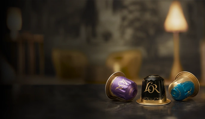L'OR Espresso Coffee Capsules on a luxurious marble tabletop