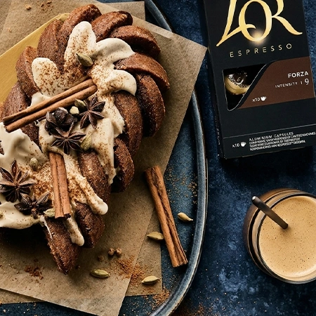 Dirty Chai Latte Cake next to a pack L'OR Espresso Coffee capsule and crema-rich coffee cup