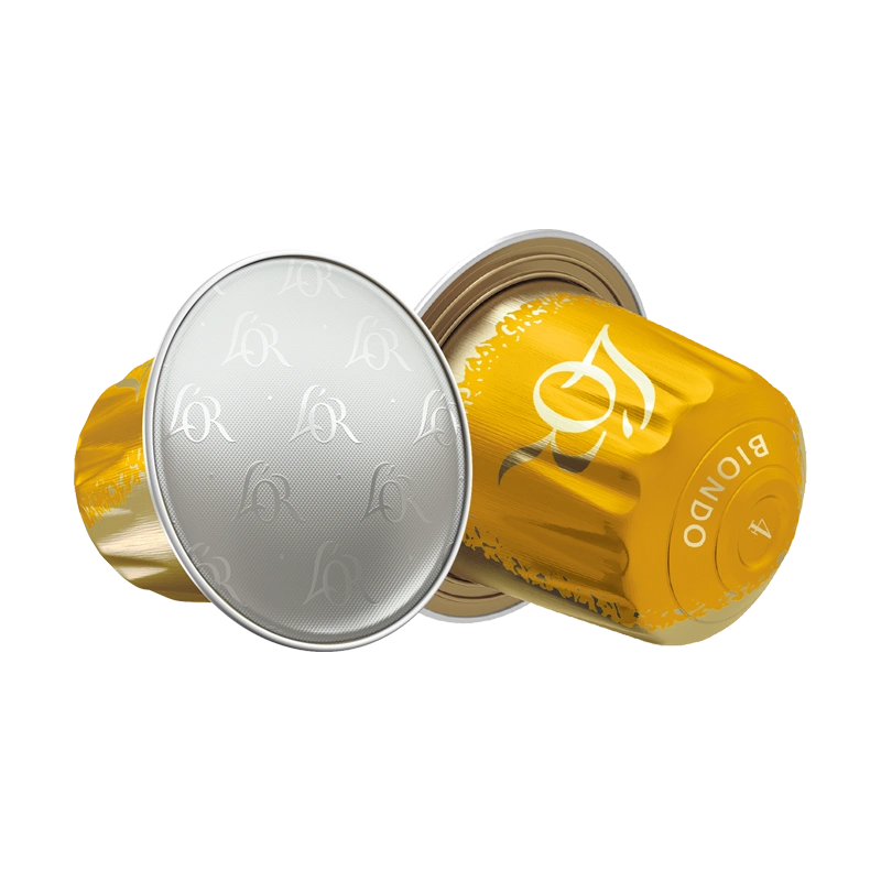 Silver and yellow L'OR coffee capsules on a white background.